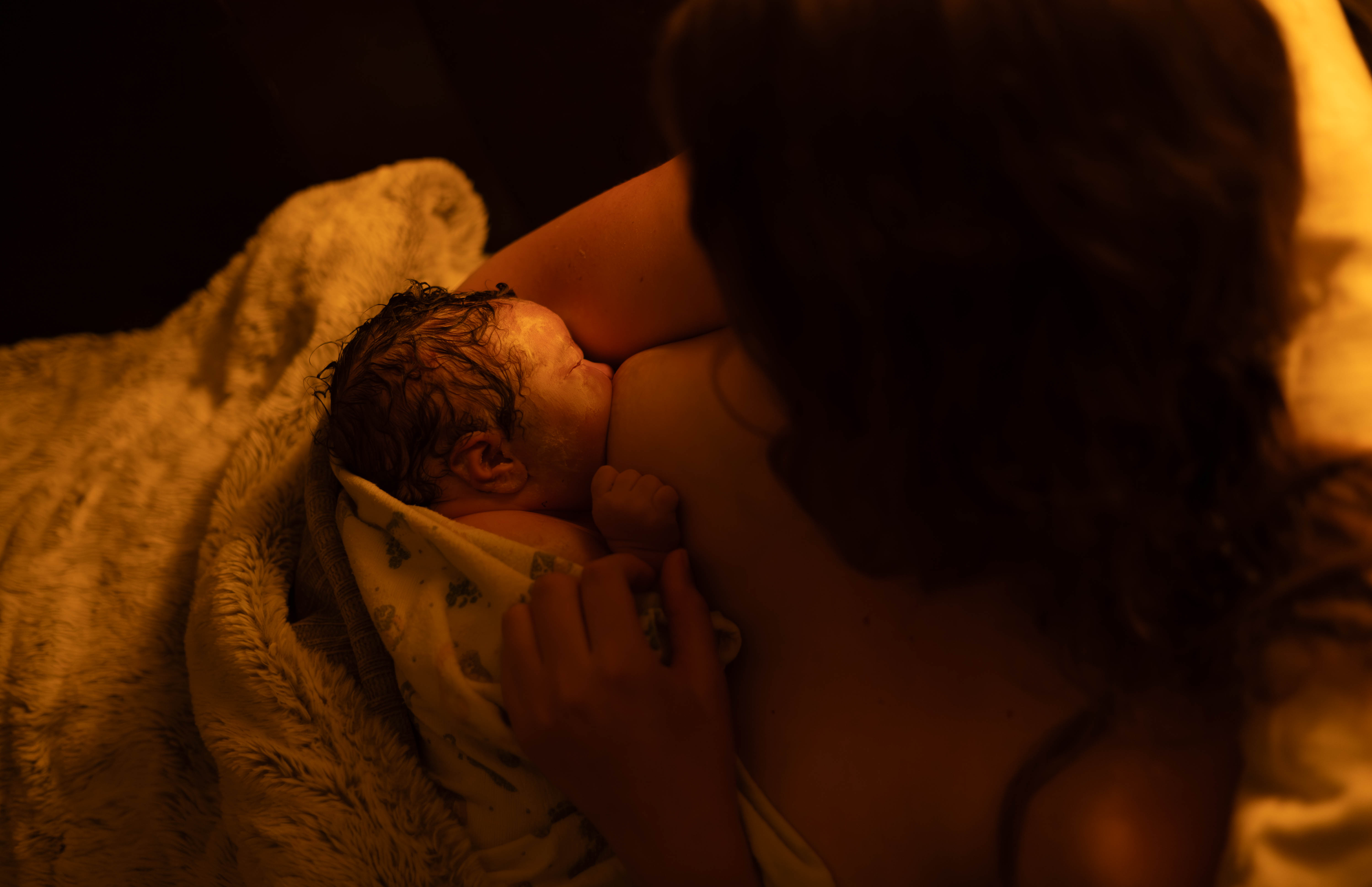 Newborn baby resting on mother's chest after delivery