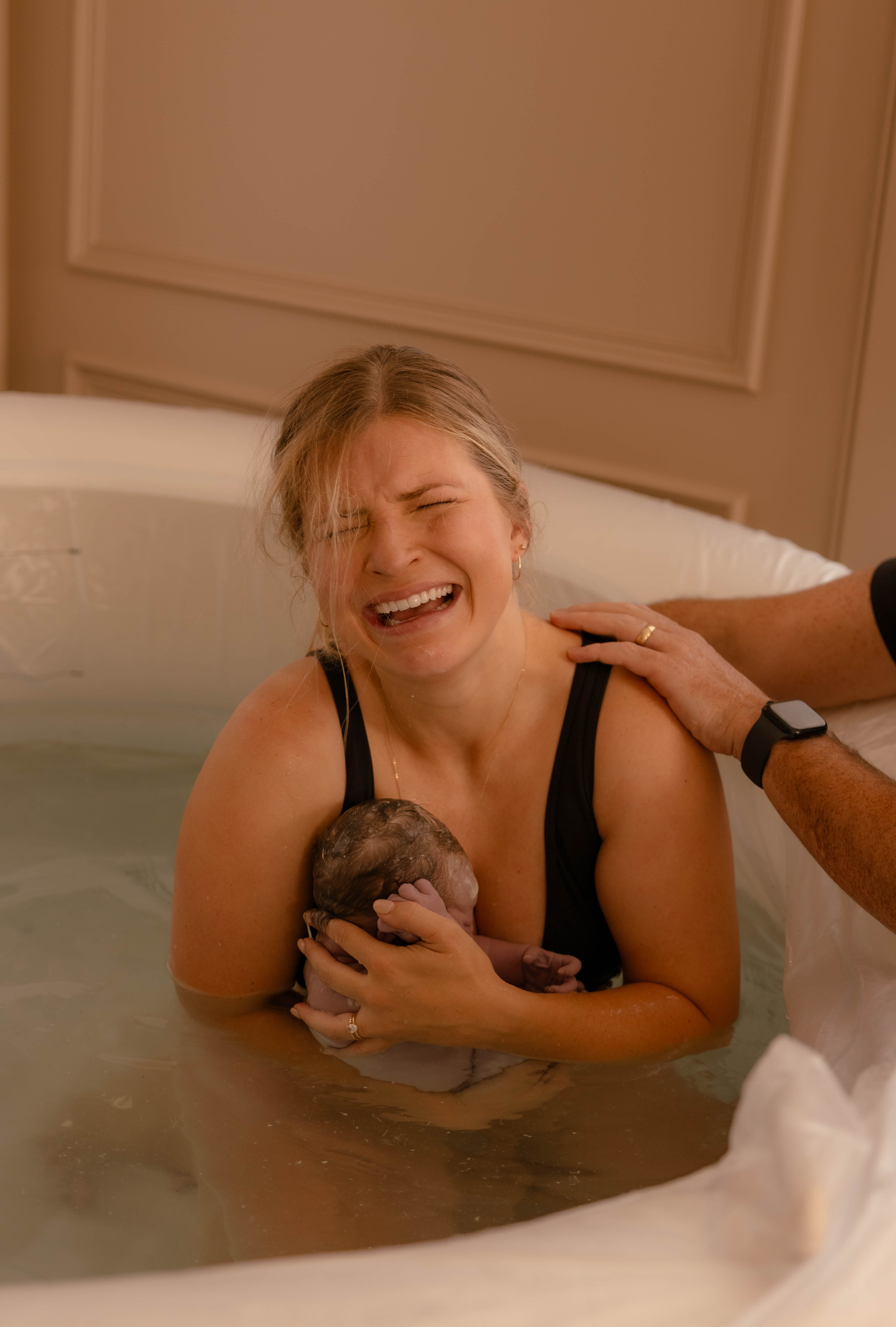 Mother embracing newborn during first hours of life