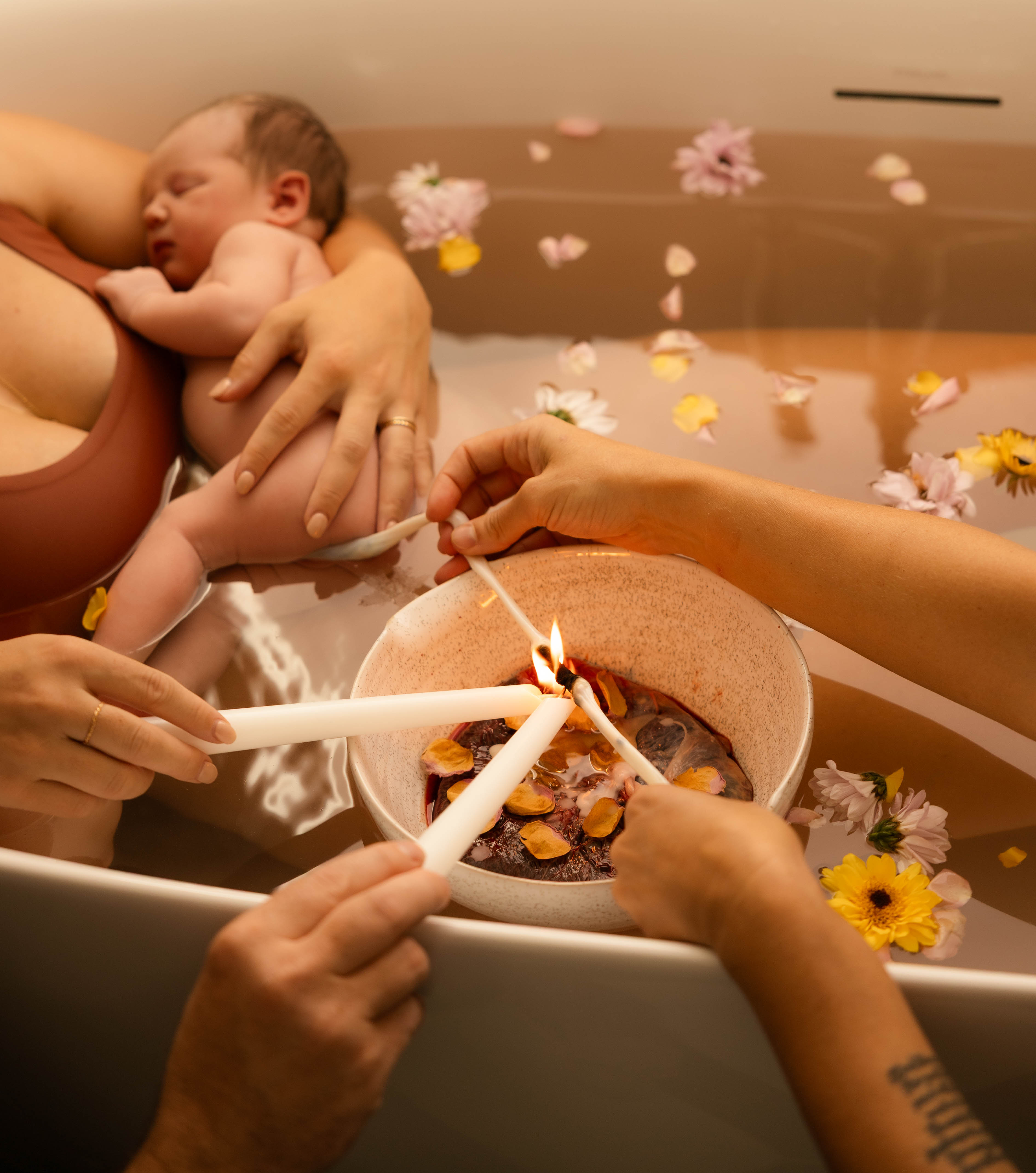 Mother holding newborn baby during golden hour after birth